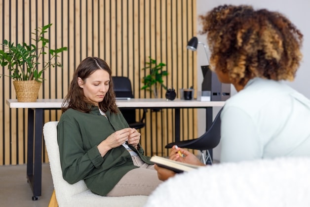 psychologist conducts an appointment with a woman patient in a mental health facility.