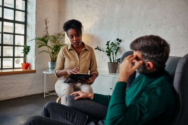 man in therapy with psychologist.