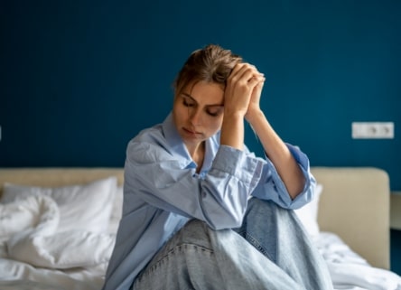 young woman sitting on floor upset